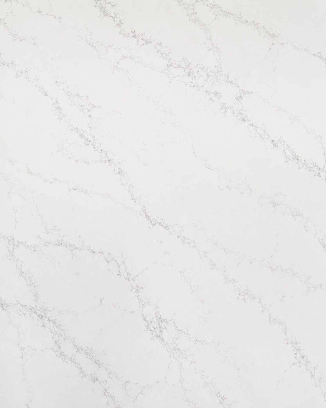 Close-up texture of Caesarstone white quartz featuring subtle gray veining and a clean contemporary surface pattern.